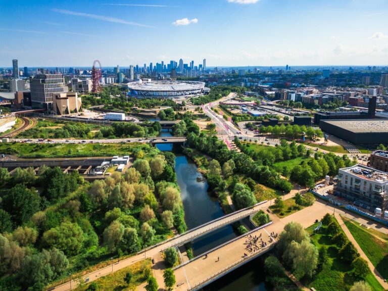 Aerial view of Queen Elizabeth Olympic Park showing the London Stadium, the ArcelorMittal Orbit and the Lee Navigation waterway, with the City of London skyline on the horizon