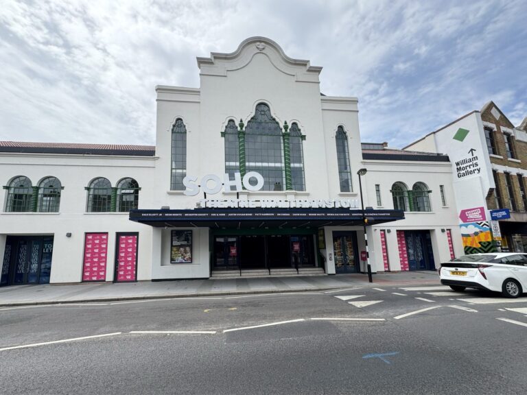 The white Art Deco facade of Soho Theatre Walthamstow, with its restored marquee and the William Morris Gallery signpost visible to the right