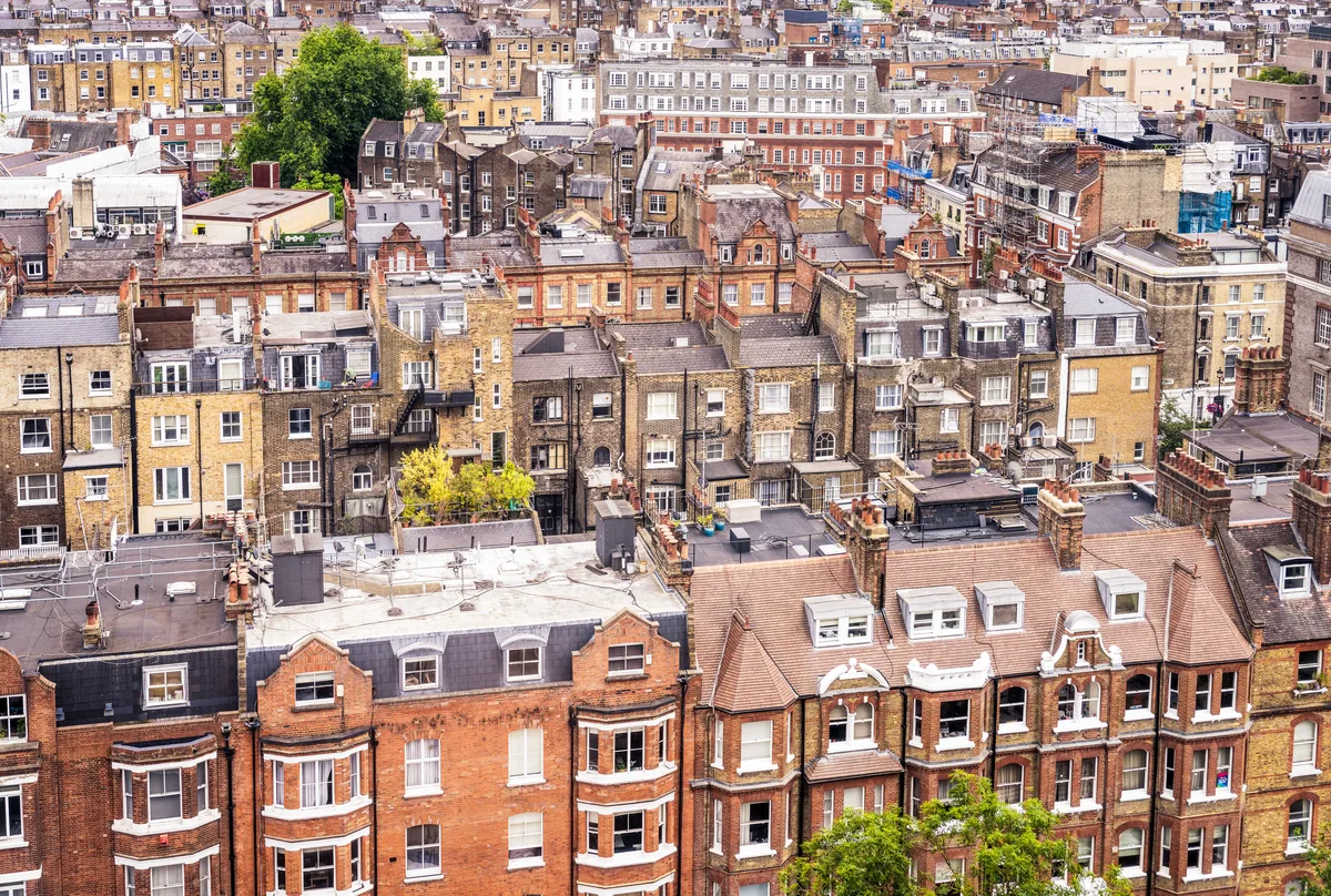 View across a London residential district showing a mix of Victorian terraces, mansion blocks, and converted flats stretching to the horizon.